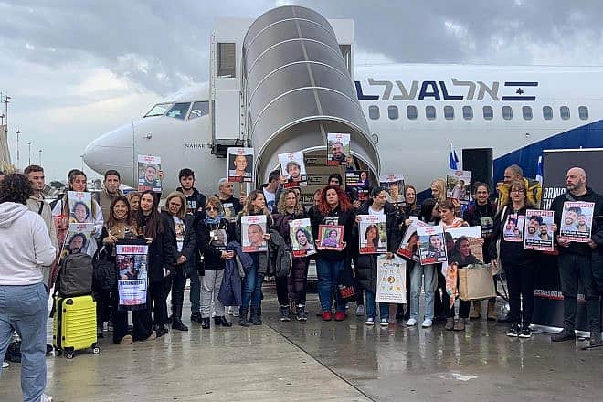 Families of captives in Gaza stand by the chartered plane that will take them to The Hague, at Ben-Gurion International Airport, Feb. 14, 2024. Photo by Nathalie Hamou.