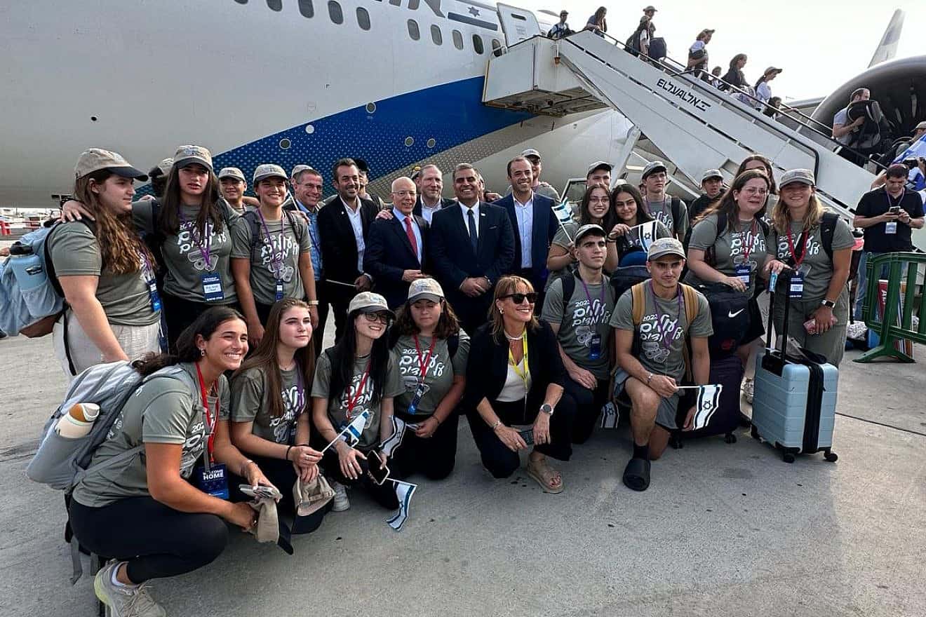 Israeli Aliyah and Integration Minister Ofir Sofer (standing, center) at Ben-Gurion International Airport with new immigrants from the United States who plan to enlist in the Israel Defense Forces. Credit: Courtesy.