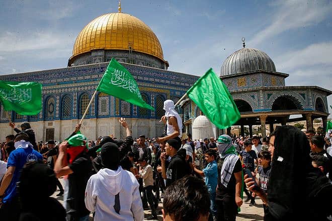Muslims wave Hamas flags after Friday prayers during Ramadan on the Temple Mount in Jerusalem, April 22, 2022. Photo by Jamal Awad/Flash90.