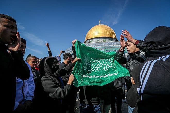 Palestinians wave a Hamas banner on the Temple Mount in Jerusalem, Jan. 27, 2023. Photo by Jamal Awad/Flash90.
