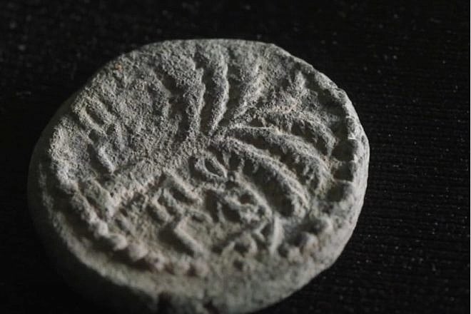 The ancient Hebrew inscription reads “Eleazar the Priest.” On the reverse side is a bunch of grapes and the test “Year One of the Redemption of Israel.” Credit: Israel Antiquities Authority.