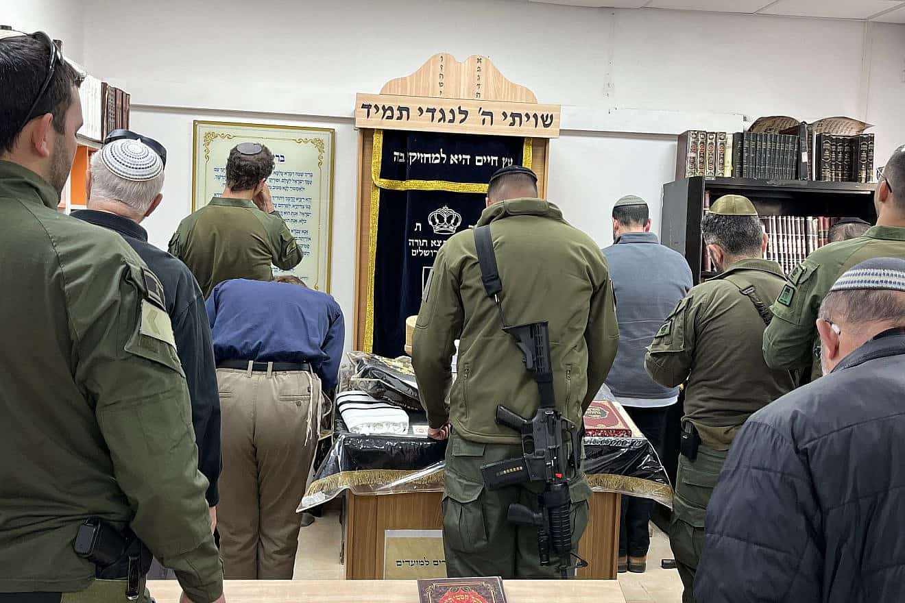 Soldiers and families of soldiers who fell in battle against Hamas pray at the renovated synagogue at the Lamed-Hey IDF base in Gush Etzion, on March 4, 2024.  Photo by Josh Hasten.