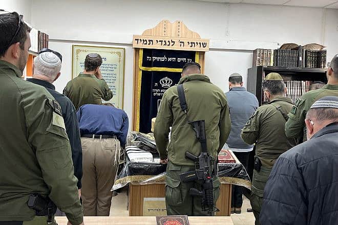 Soldiers and families of soldiers who fell in battle against Hamas pray at the renovated synagogue at the Lamed-Hey IDF base in Gush Etzion, on March 4, 2024.  Photo by Josh Hasten.