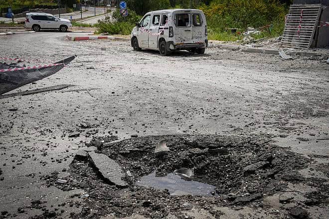 Damage in Kiryat Shmona after a Hezbollah rocket hit a parking area, March 27, 2024. Photo by Ayal Margolin/Flash90.