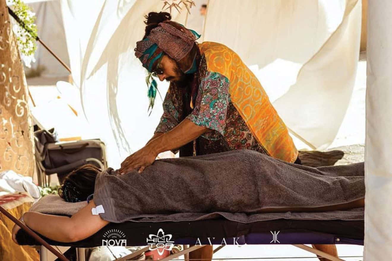 Dor Kapah gives a massage to a music festival participant. Photo by Inor Kagno.