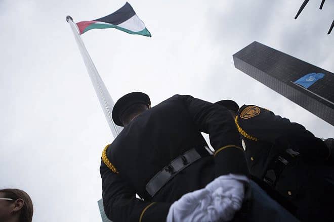 A Palestinian flag is raised at the United Nations headquarters in New York, Sept. 30, 2015. Photo by Amir Levy/Flash90.