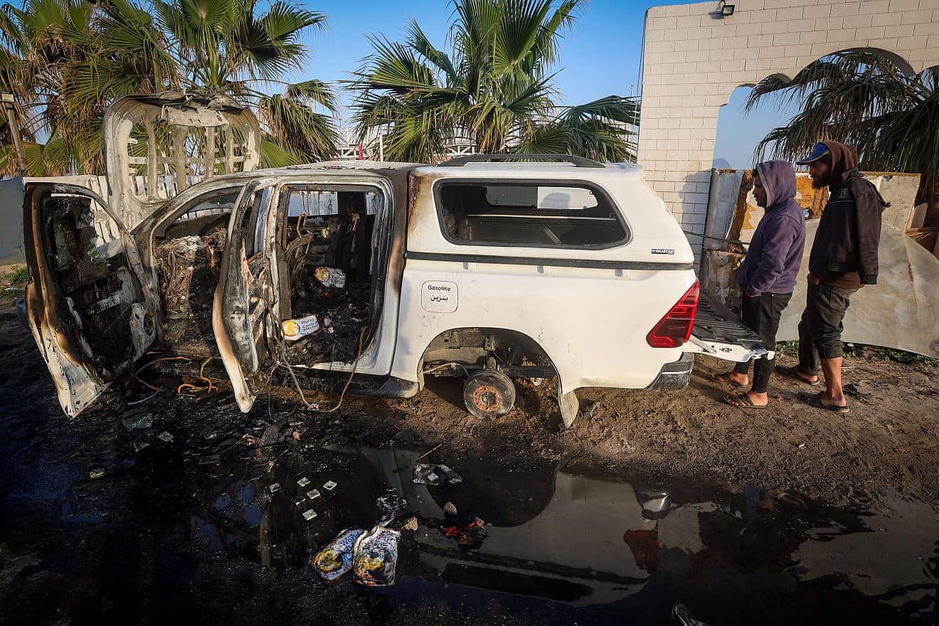 Palestinians inspect a car of the World Central Kitchen aid organization that was hit by an Israeli airstrike, in Deir al-Balah, the Gaza Strip, April 2, 2024. Photo by Atia Mohammed/Flash90.