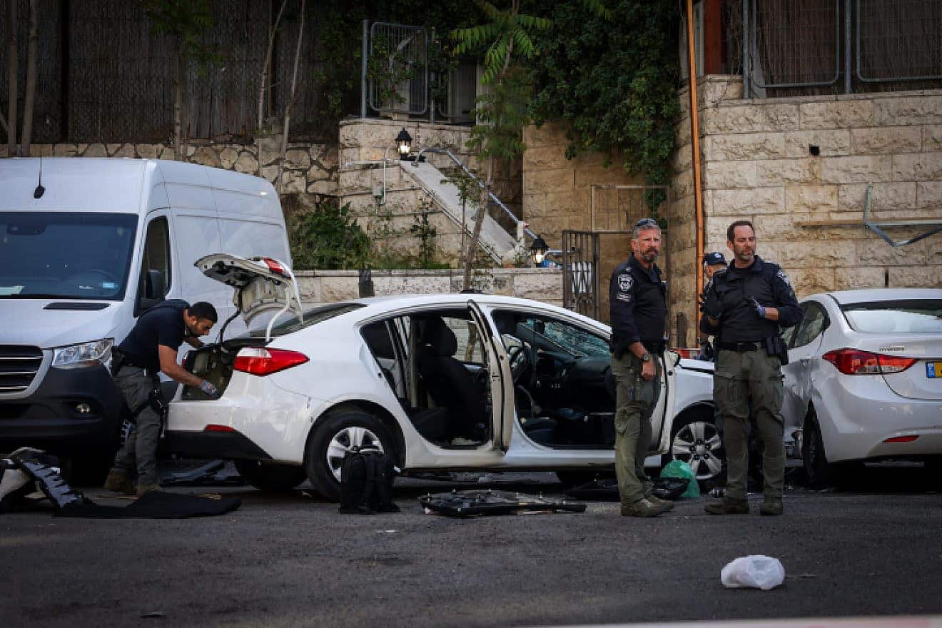 Security personnel at the site of a car-ramming attack in Jerusalem that wounded three Israelis on April 22, 2024. Photo by Chaim Goldberg/Flash90.