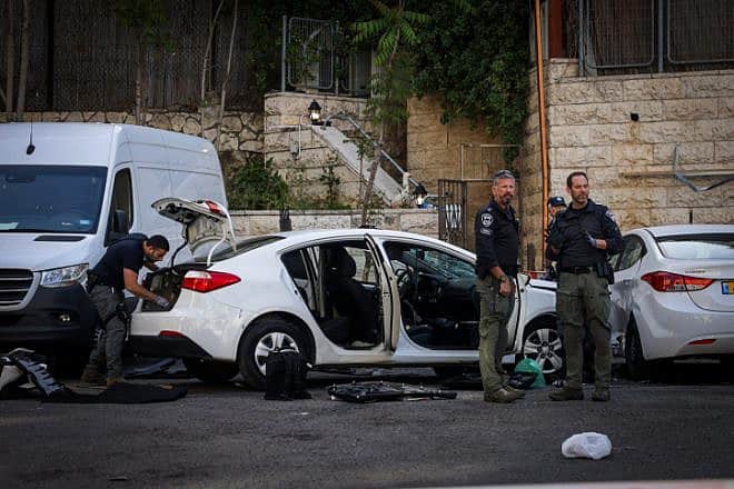 Security personnel at the site of a car-ramming attack in Jerusalem that wounded three Israelis on April 22, 2024. Photo by Chaim Goldberg/Flash90.