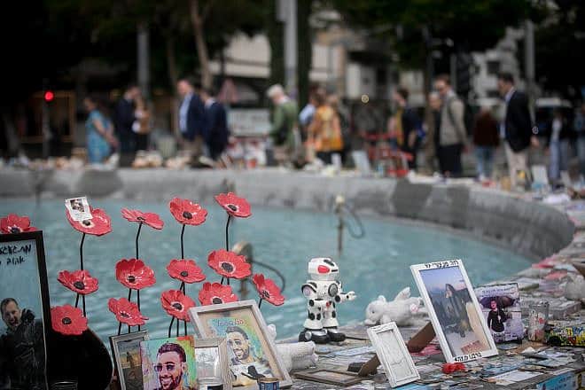 Israelis walk past candles and photos of the victims killed and held hostage by Hamas terrorists in Gaza since the Oct. 7 massacre, on Dizengoff Square in Tel Aviv on April 8, 2024. Photo by Miriam Alster/Flash90.