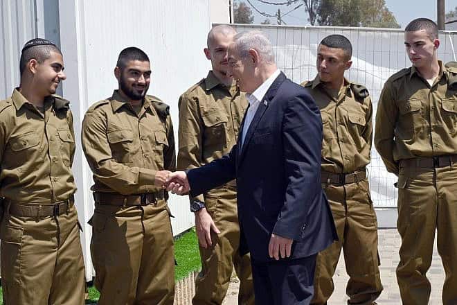 Israeli Prime Minister Benjamin Netanyahu with IDF recruits at the Tel HaShomer induction base, April 16, 2024. Photo by Haim Zach/GPO.