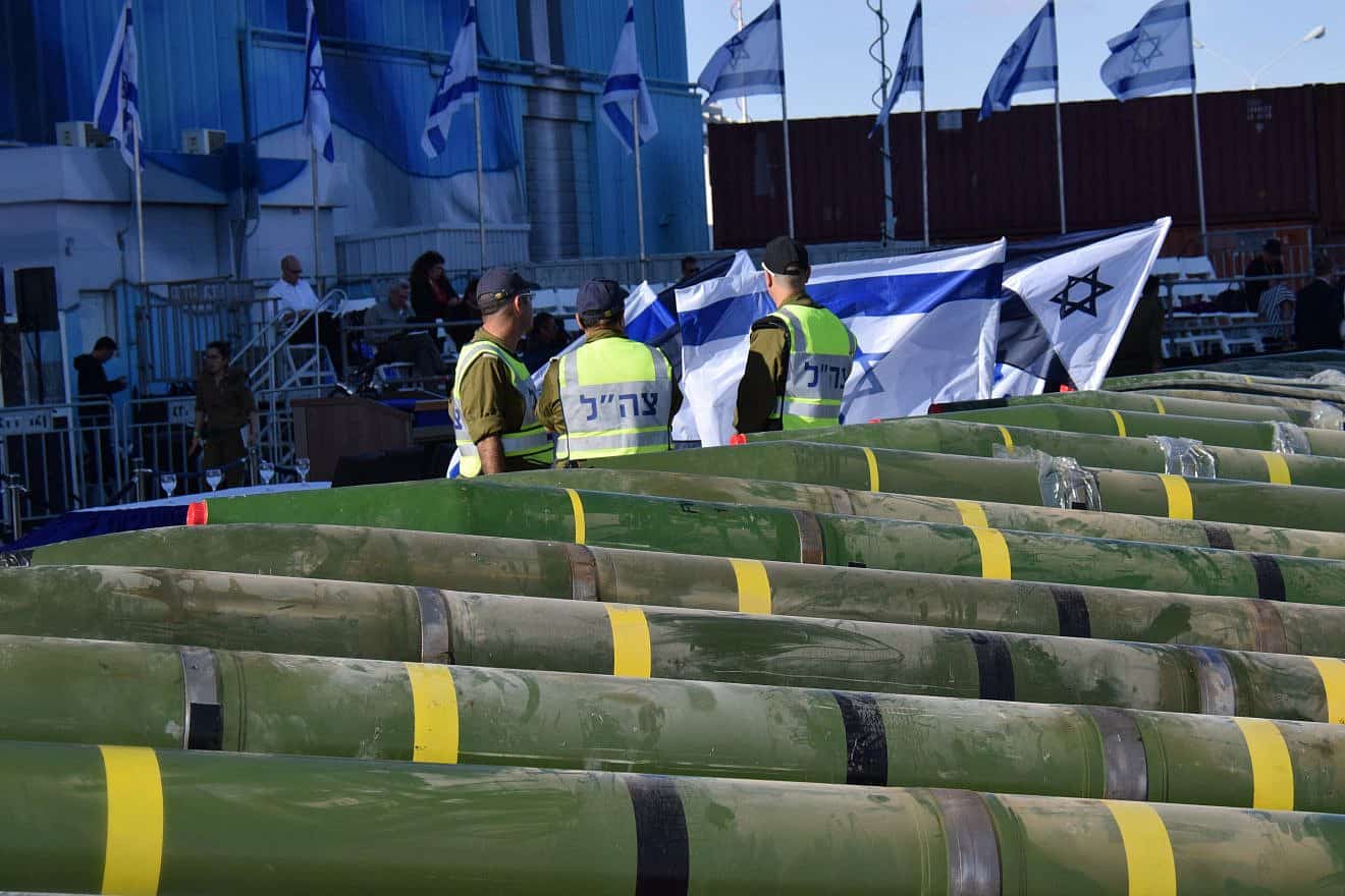 IDF Navy soldiers examine dozens of mortar shells and rockets on display, at a military port in the southern Israeli city of Eilat, after being seized from the Panama-flagged KLOS C civilian cargo ship in the Red Sea, and which according to the Israeli military was carrying dozens of advanced rockets from Iran destined for Palestinian militants in Gaza, March 10, 2014. Photo by Yehuda Ben Itach/Flash90.