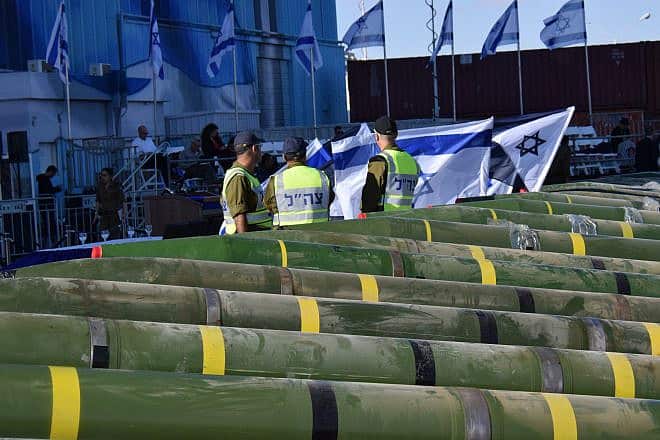 IDF Navy soldiers examine dozens of mortar shells and rockets on display, at a military port in the southern Israeli city of Eilat, after being seized from the Panama-flagged KLOS C civilian cargo ship in the Red Sea, and which according to the Israeli military was carrying dozens of advanced rockets from Iran destined for Palestinian militants in Gaza, March 10, 2014. Photo by Yehuda Ben Itach/Flash90.