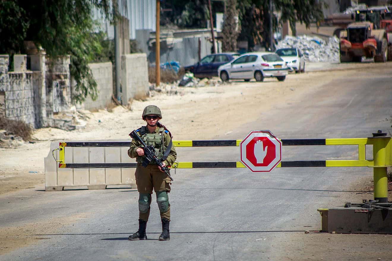 Israeli soldiers block the entrance to the village of Beita in northern Samaria during searches for the terrorist who carried out an attack in Huwara, on Aug. 20, 2023. Photo by Nasser Ishtayeh/Flash90.