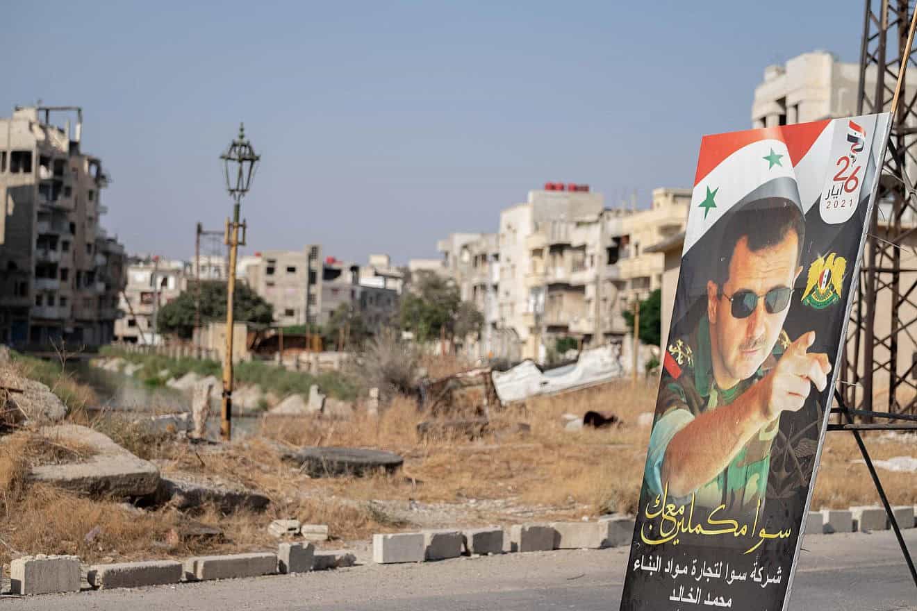 A poster of President Bashar Assad in Homs's destroyed city center during the Syrian civil war, Aug. 25, 2021. Photo by Lena Ha/Shutterstock.