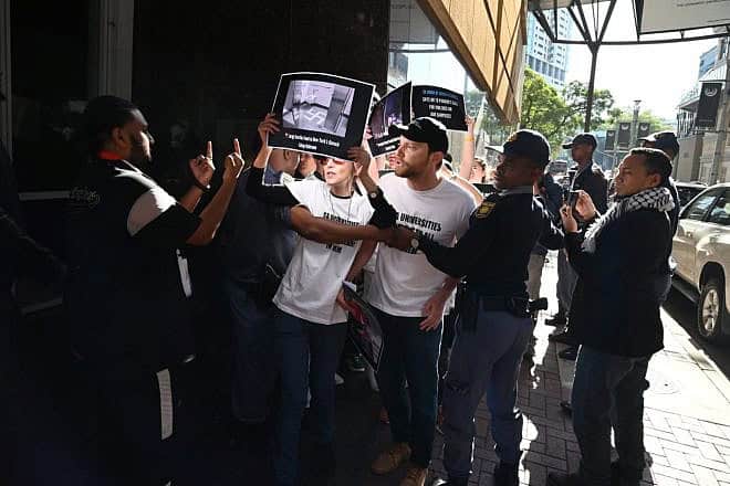 Anti-Israel activists abuse Jewish demonstrators as police remove them outside the Sandton Convention Centre in Johannesburg, May 10, 2024. Credit: Courtesy of Neil McCartney.