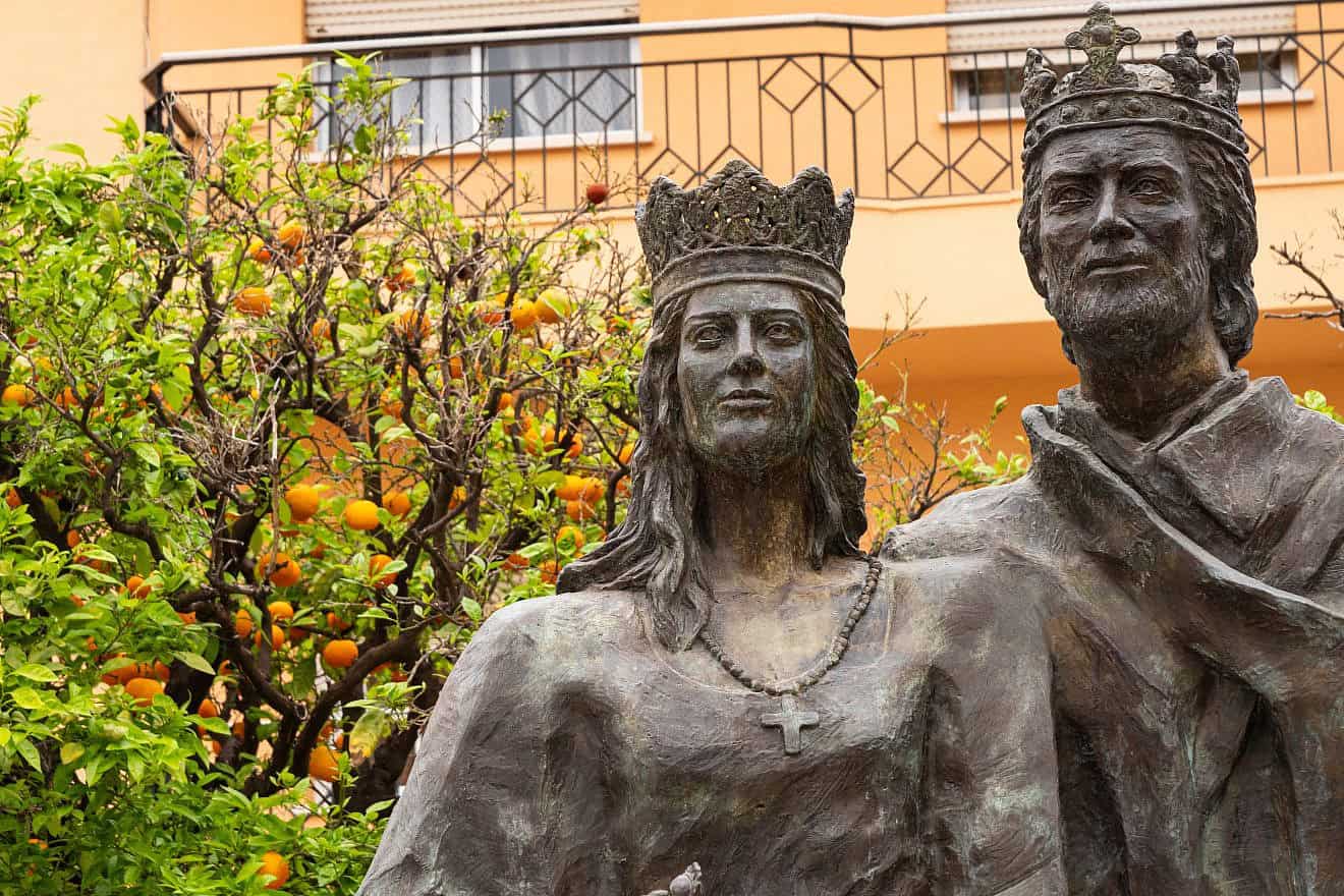 Bronze statues of Queen Isabella I of Castile and King Ferdinand II of Aragon, 15th-century rulers of Spain, among orange trees in the Plaza del Ayuntamiento at Fuengirola in southern Spain. Credit: Graham King/Shutterstock.