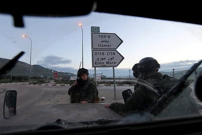 Israeli soldiers block a road near Huwara, south of the Samaria city of Nablus (Shechem), March 12, 2011. Photo by Nati Shohat/Flash90.