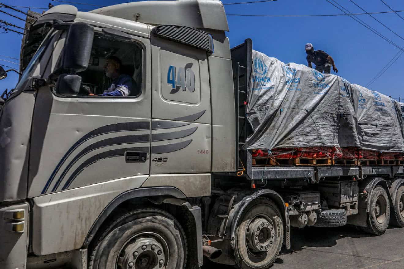 Terrorists on trucks loaded with aid entering Gaza through Israel's Kerem Shalom Crossing, April 3, 2024. Photo by Abed Rahim Khatib/Flash90.