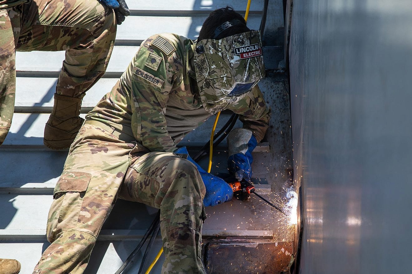 U.S. Army Spc. Connor Schloesser welds the bow ramp of a landing craft utility vessel as part of repair operations for the Joint Logistics Over-the-Shore pier at the Port of Ashdod, Israel, May 14, 2024. Credit: Spc. Riley Anfinson/U.S. Army photo.