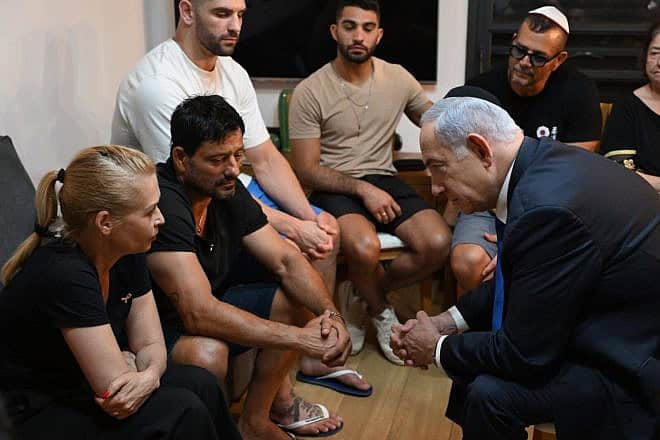 Israeli Prime Minister Benjamin Netanyahu talks with the family of IDF Sgt. First Class (res.) Omer Smadga, who was killed in action in the Gaza Strip, June 24, 2024. Credit: Haim Zach/GPO