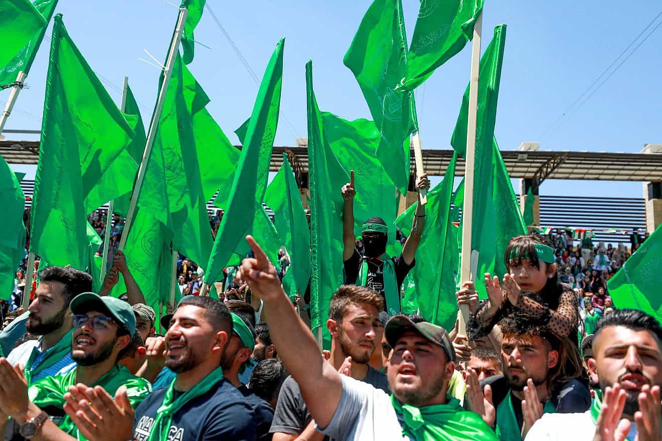 Palestinian students supporters of the Hamas movement wave the movement's flag during a rally at Birzeit University, near the West Bank city of Ramallah, May 19, 2022. Photo by Flash90.