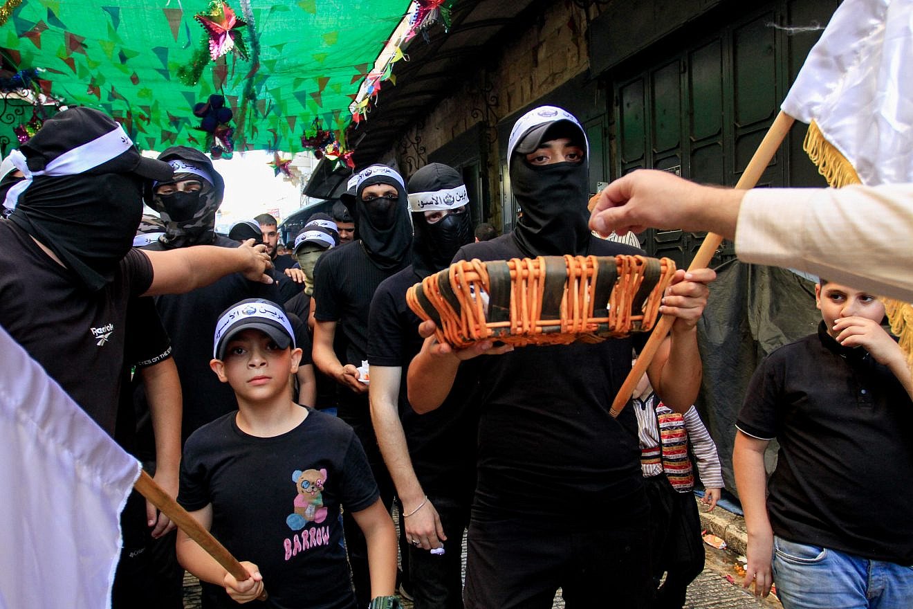Members of the Lions' Den groups give away sweets to people during celebrations of the birth of the Prophet Muḥammad in Nablus, September 27, 2023. Photo by Nasser Ishtayeh/Flash90.