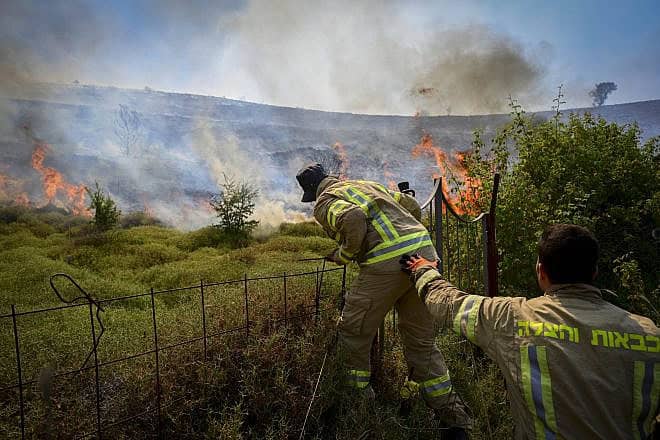 Israeli firefighters try to extinguish a fire sparked by missiles launched from Lebanon, near the northern city of Safed, June 12, 2024. Photo by Michael Giladi/Flash90.