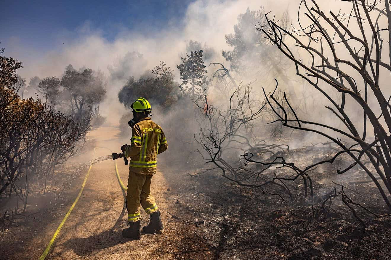 A firefighter tries to extinguish a blaze near the Israel Museum in Jerusalem, June 2, 2024. Photo by Chaim Goldberg/Flash90.