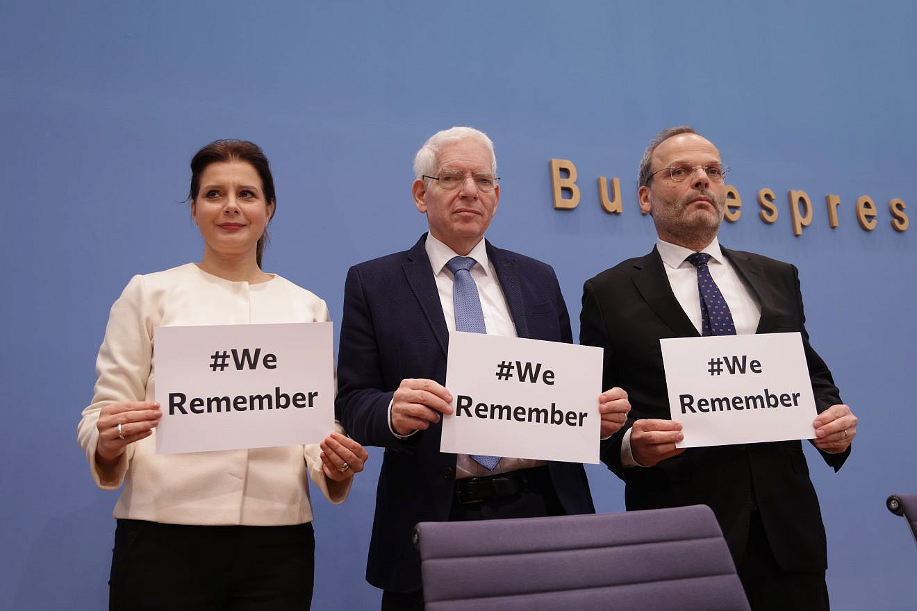 From left: Andrea Despot, chair of the EVZ Foundation; Joseph Schuster, president of Germany's Central Council of Jews; and Felix Klein, Germany's federal antisemitism commissioner, pose with placards stating "We remember," in reference to International Holocaust Remembrance Day in Berlin, Jan. 25, 2024. Photo by Sean Gallup/Getty Images.