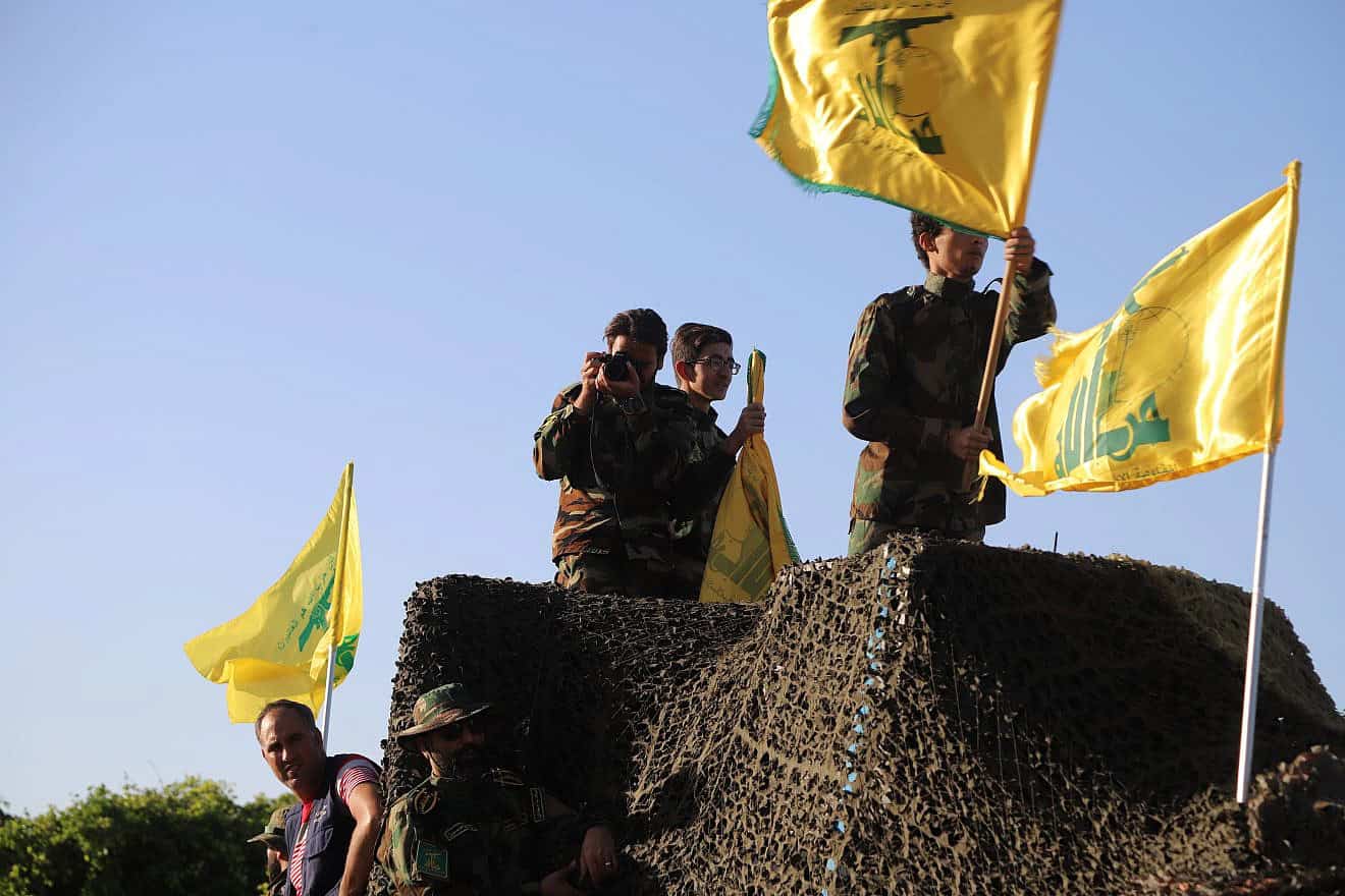 A Hezbollah gunman in Tyre in Southern Lebanon on Liberation Day, which marks the withdrawal of Israeli forces from the country in 2000, May 25, 2021. Credit: Crop Media/Shutterstock.