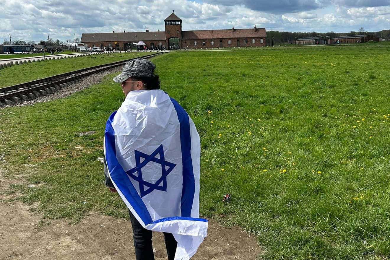 Andrew Weiss, a rising senior at the University of Michigan, at the grounds of Auschwitz on a trip to Poland in April 2024. Credit: Courtesy.