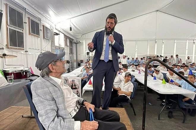 Rabbi Yakov Garfinkel, Lubavitch Educational Center Jewish day school in Miami, addresses the crowd at Holocaust survivor and Florida resident Saul Dreier’s 99th birthday party. Credit: Lubavitch Educational Center Miami via Chabad.org/News.