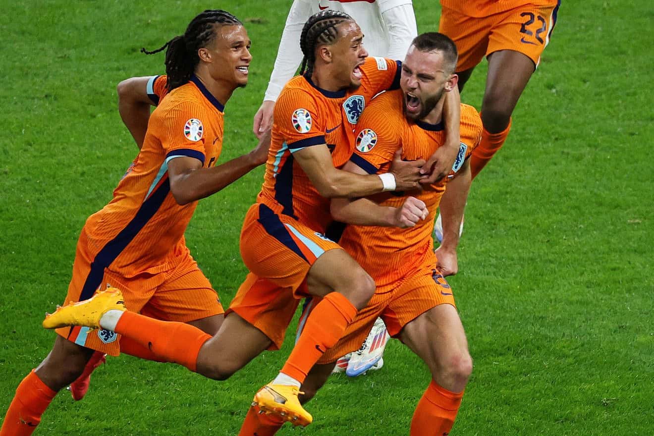 Dutch defender Stefan de Vrij (right) celebrates with defender Nathan Ake (left) and forward Xavi Simons after scoring his team's first goal during the UEFA Euro 2024 quarterfinal match against Turkey at the Olympic Stadium in Berlin on July 6, 2024. Photo by Ronny Hartmann/AFP via Getty Images.