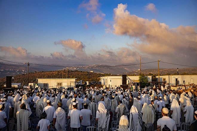 Israelis attend a special prayer event in the newly recognized town of Evyatar in Samaria, July 7, 2024. Photo by Chaim Goldberg/Flash90.