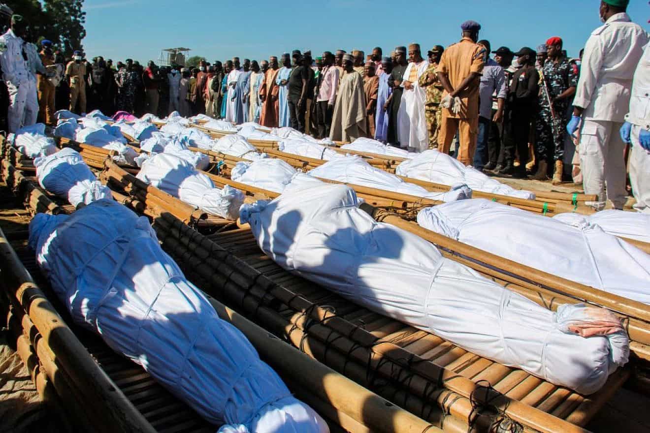 Mourners in Zabarmari, Nigeria attend the funeral of 43 farm workers, who were killed by Islamist Boko Haram terrorists, on Nov. 29, 2020. Credit: Audu Marte / AFP via Getty Images.