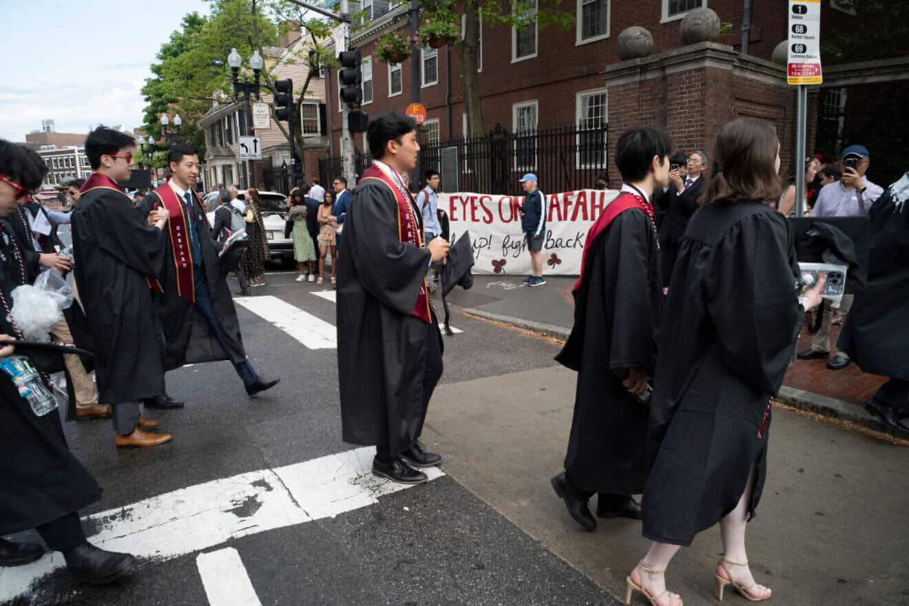 Harvard University students walk past anti-Israel demonstrators outside Harvard Yard during the class of 2024 graduation ceremony in Cambridge, Mass., on May 23, 2024. Photo by Rick Friedman/AFP via Getty Images.