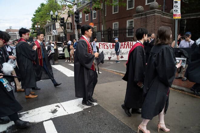 Harvard University students walk past anti-Israel demonstrators outside Harvard Yard during the class of 2024 graduation ceremony in Cambridge, Mass., on May 23, 2024. Photo by Rick Friedman/AFP via Getty Images.