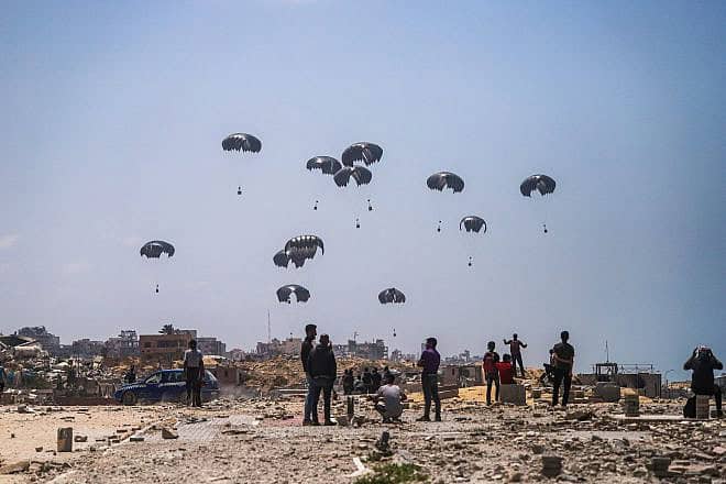 Aid packages are dropped on Gaza from the air, April 30, 2024. Photo by Abood Abusalama/Middle East Images/AFP via Getty Images.