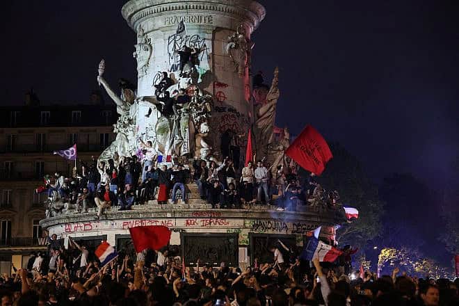 Participants gather during an election night rally following the first results of the second round of France's legislative election at Place de la Republique in Paris on July 7, 2024. A loose alliance of French left-wing parties thrown together for snap elections was on course to become the biggest parliamentary bloc and beat the far right, according to shock projected results. Photo by Emmanuel Dunand/AFP via Getty Images.