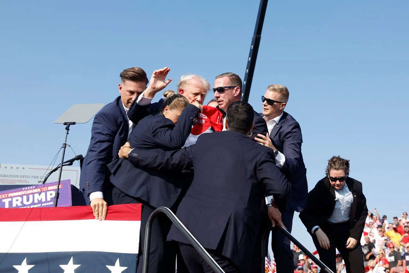 Republican presidential candidate former President Donald Trump is rushed offstage after an assassination attempt at a rally in Butler, Pennsylvania on July 13, 2024. Credit: Anna Moneymaker/Getty Images.