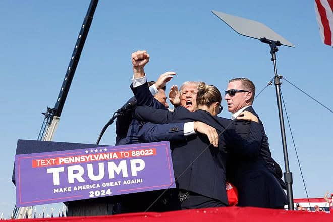 Republican presidential candidate former President Donald Trump is rushed offstage following an assassination attempt at a rally in Butler, Pennsylvania on July 13, 2024. Credit: Anna Moneymaker/Getty Images.