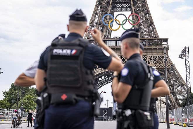 French police patrol the Eiffel tower ahead of Paris 2024 Olympic Games on July 20, 2024 in Paris, France. Photo by Kevin Voigt/GettyImages.