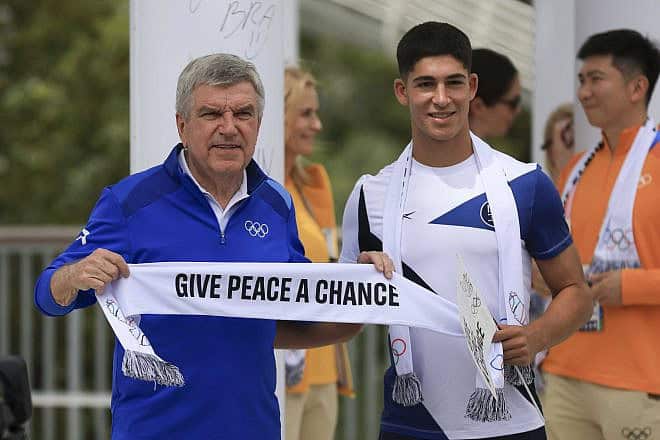 IOC President Thomas Bach and Niv Yehoshua of Team Israel interact during the Athletes' Call for Peace event at the Olympic Village Plaza ahead of the Paris 2024 Olympic Games on July 22, 2024 in Saint-Denis, Paris, France. Photo by Maja Hitij/Getty Images.