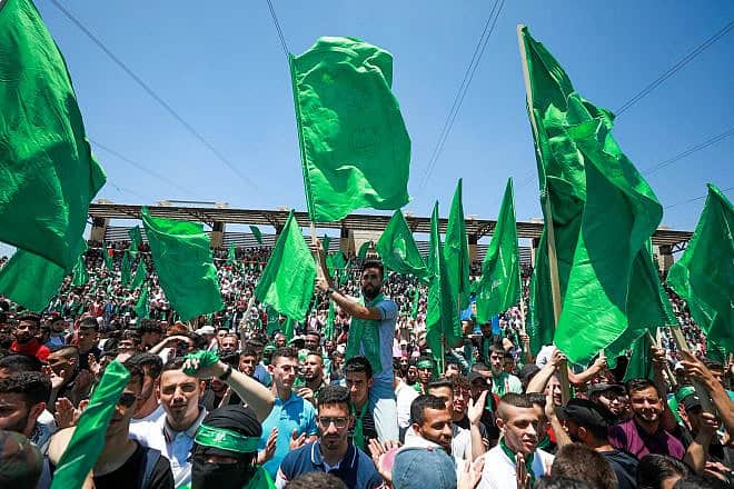 Hamas supporters wave the movement's flags during a rally at Birzeit University, north of Ramallah, May 19, 2022. Photo by Flash90.