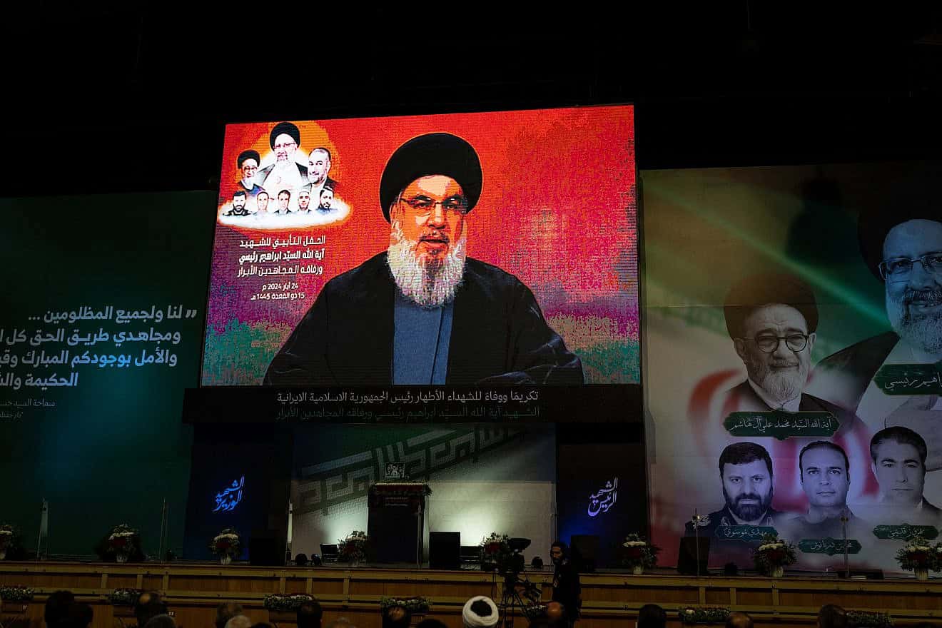 Lebanese watch a televised speech by Hezbollah Secretary General Hassan Nasrallah in a hanger in the Beirut suburb of Dahiyeh following the death of Iranian President Ebrahim Raisi in a helicopter crash, May 24, 2024. Photo by Oliver Marsden/Middle East Images/AFP via Getty Images.