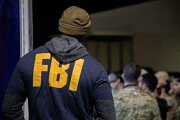 An FBI agent listens to the operation pre-briefing for Operation Dead Hand in Los Angeles on Jan. 30, 2024. Credit: Federal Bureau of Investigation.