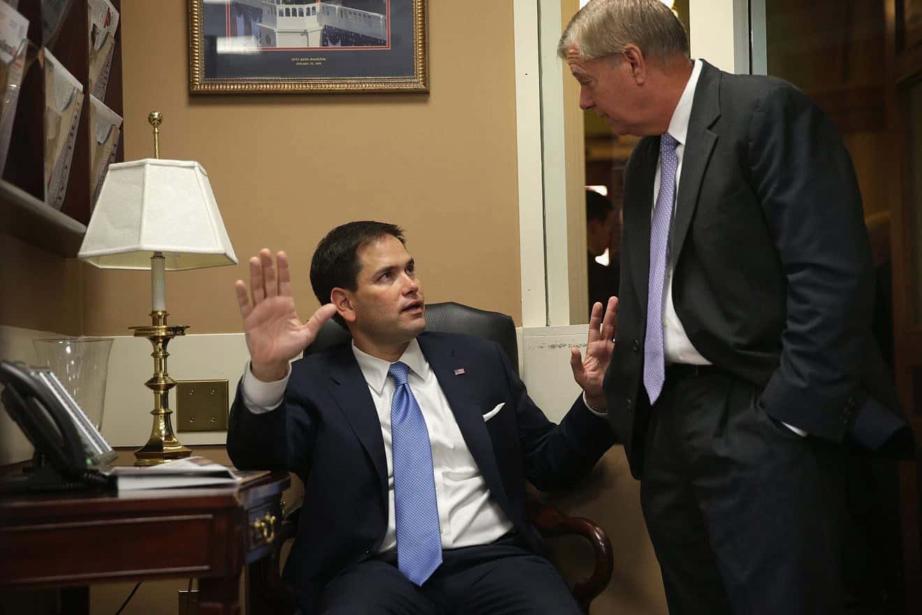 Sen. Marco Rubio (left) speaks to Sen. Lindsey Graham before a news conference on Capitol Hill in Washington on the conflict between Israel and Hamas, July 24, 2014. Photo by Alex Wong/Getty Images.