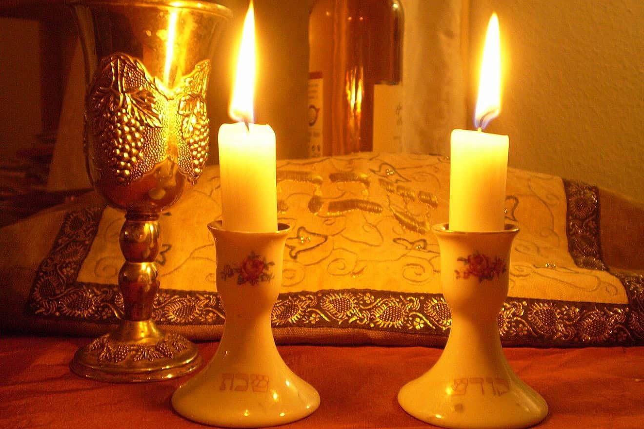 Shabbat candles and covered challah. Credit: Olaf.herfurth via Wikimedia Commons.