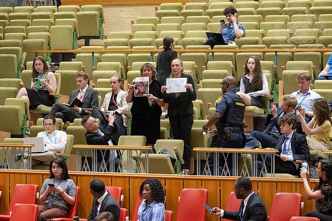 Yaffa Ben-David, who leads the Israel Teachers Union, and a yet-unidentified woman to her left protest during the U.N. Security Council meeting on the situation in the Middle East, including the Palestinian question, on July 17, 2024. Credit: Eskinder Debebe/U.N. Photo.